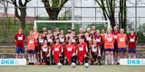 Das Liga-Team steht und kniet vor einem Tor mit DKB-Banden an dem Seiten. 