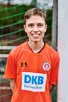 Rasmus Heidmann, im orangenen Guiding-Shirt, lächelt in die Kamera 